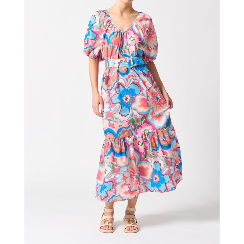 Woman wearing a colorful floral dress on a white background