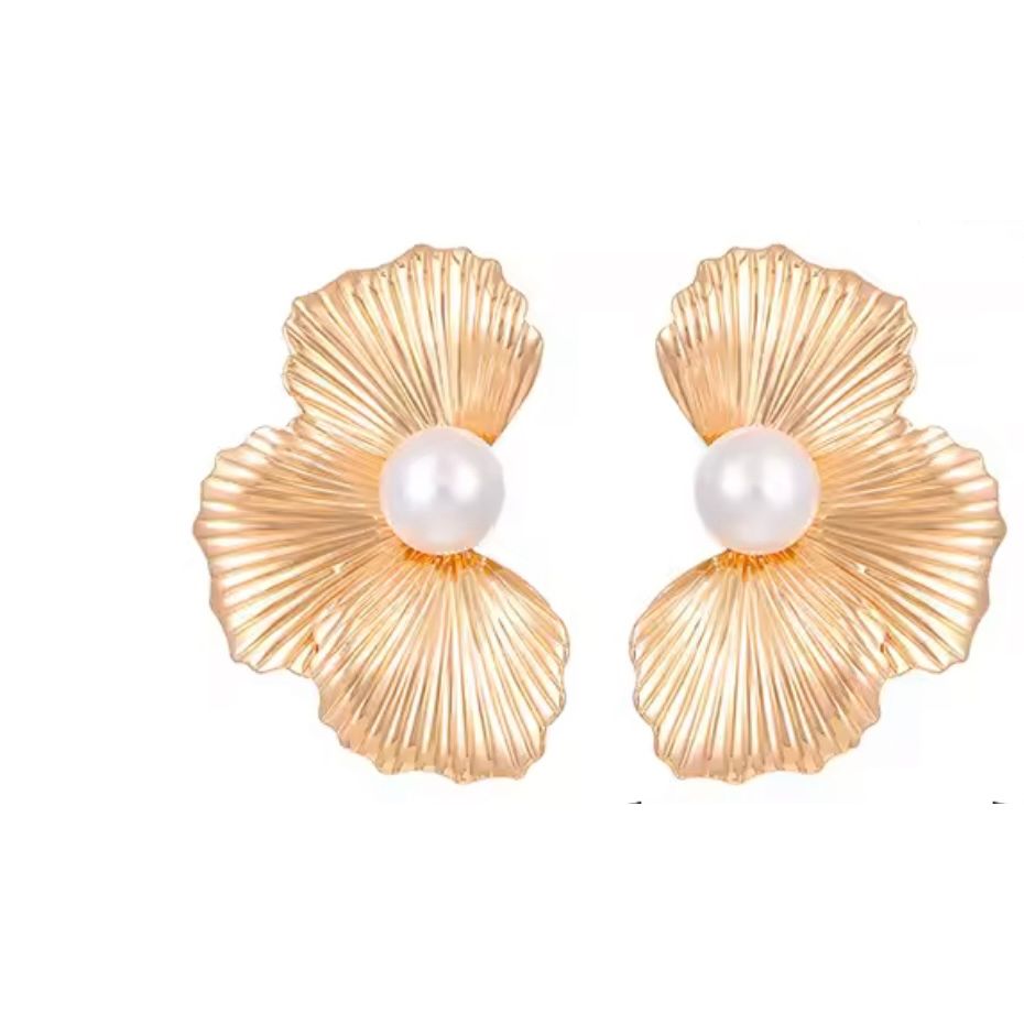 Gold shell-shaped earrings with pearl centers on a white background